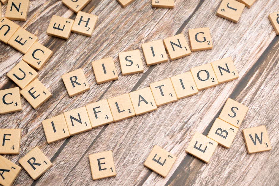 Wooden letter tiles spell 'rising inflation' symbolizing economic concerns.
