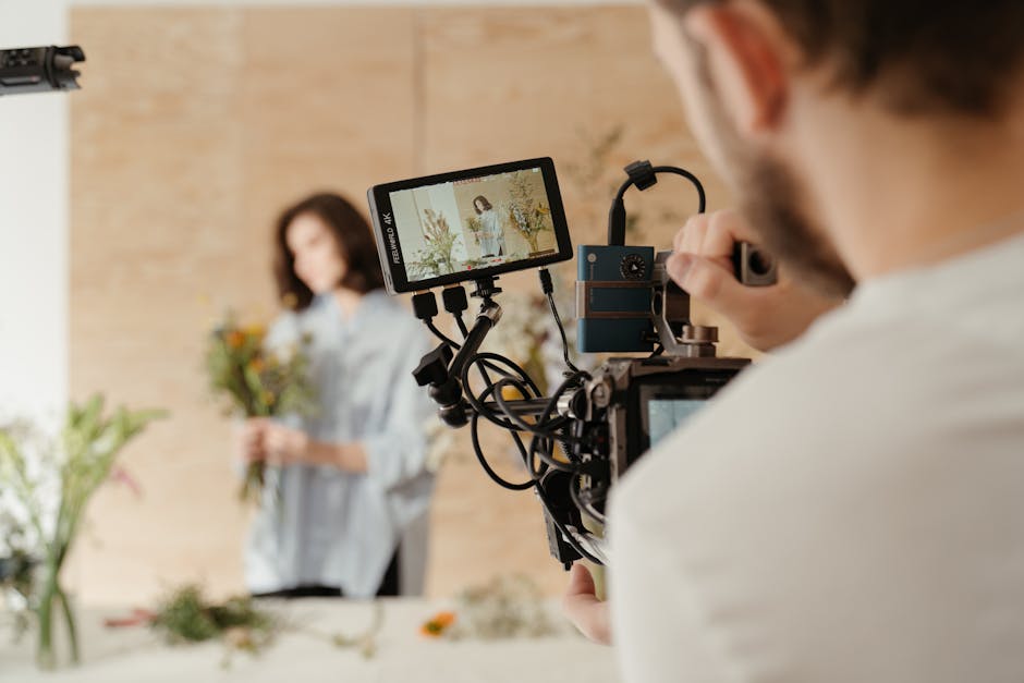 Behind the scenes of a floral arrangement being filmed with a DSLR camera.